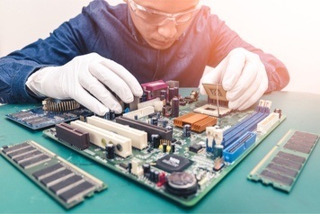 Man repairing computer motherboard