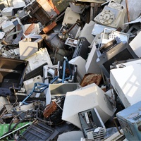 Computer and other electronic devices stacked up on a landfill.