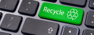 Computer recycling concept. The word "Recycle" on the green enter key button of the keyboard.