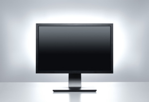 A computer monitor on a desk displays a blank screen: concept, computer peripherals, and hardware.