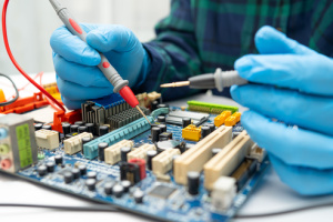 The technician uses a soldering iron to repair the inside of the hard disk, specifically the integrated circuit. This process involves understanding the concept of tools for fixing computers and utilizing their skills and knowledge.