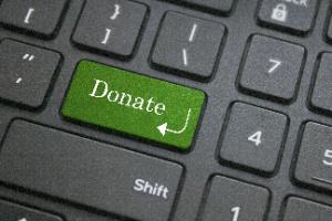 A close-up view of the donate button on a computer keyboard is shown.