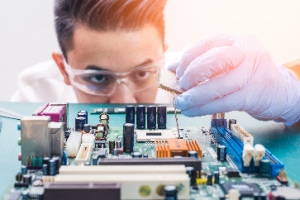 The technician is installing the CPU onto the computer motherboard socket to upgrade hardware. Upgrade computer hardware concept.